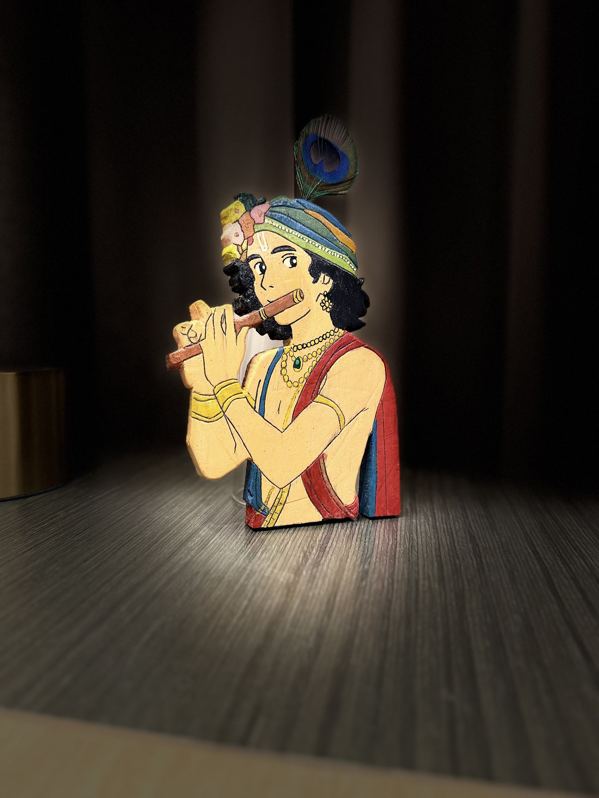 Handcrafted wooden Krishna figurine dramatic front view with rich painted details