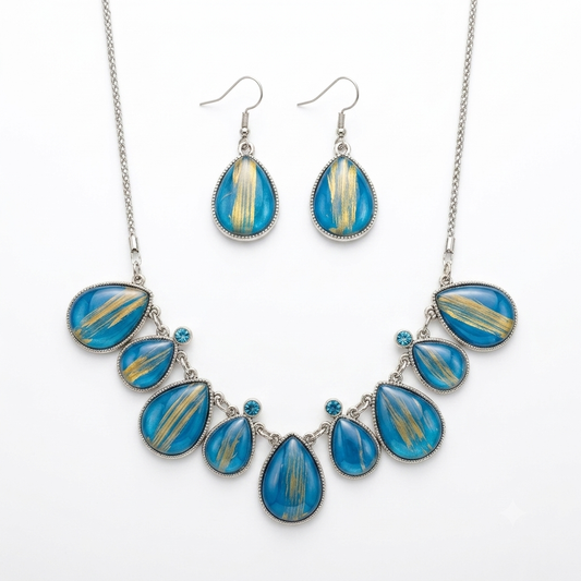Blue and gold statement necklace with matching drop earrings on white background