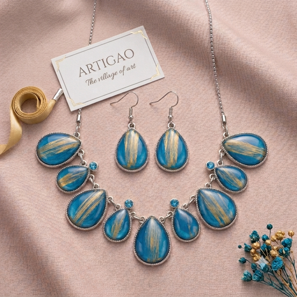 ARTIGAO blue and gold teardrop necklace and earring set on pink silk with brand card